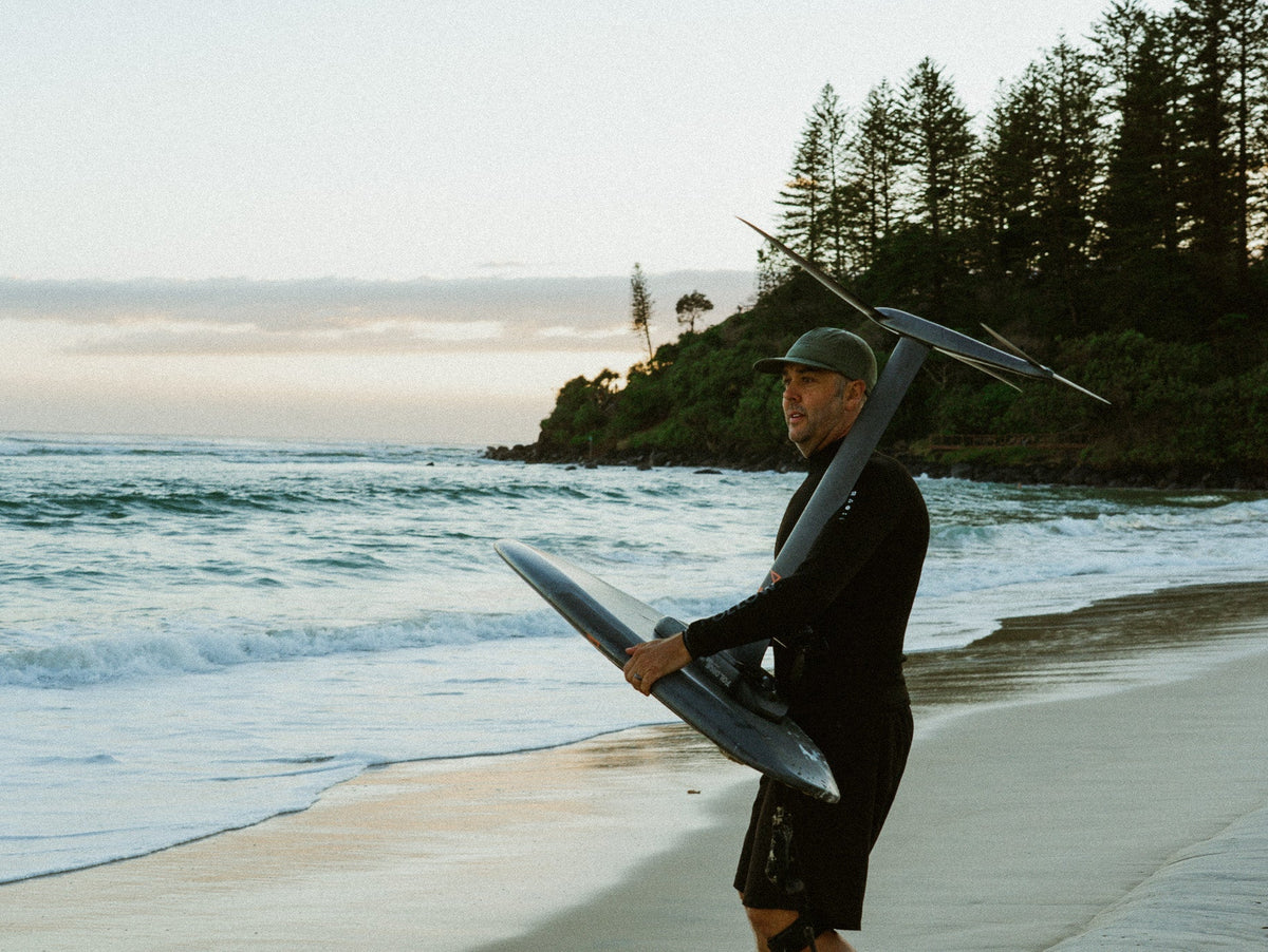 Follow founder Steve Anderson heading out for a seesion on his Foil Drive in the Follow P1 Oceana Wetty Top and Follow Welded Boardie in Black