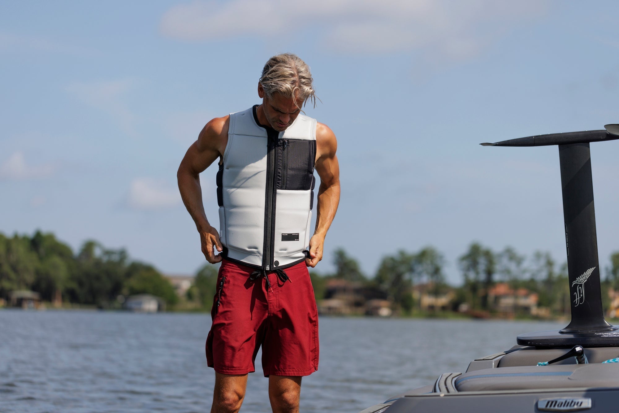 Brian Grubb gets ready for his next set wearing the Follow Affix Impact vest for a perfect fit and Water Boardie board shorts