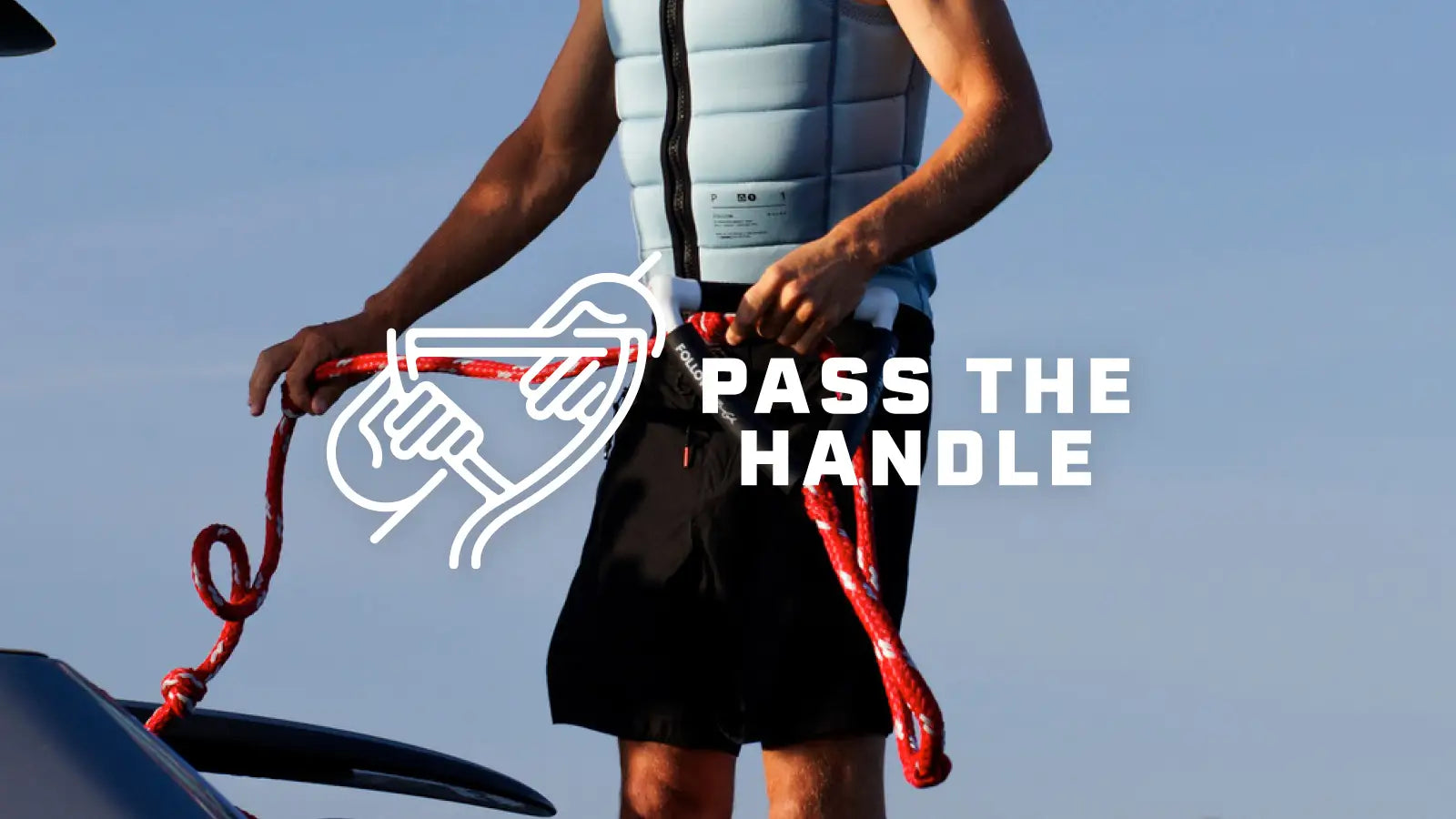 Wakeboarder standing on back of boat holding Follow branded Tow Rope